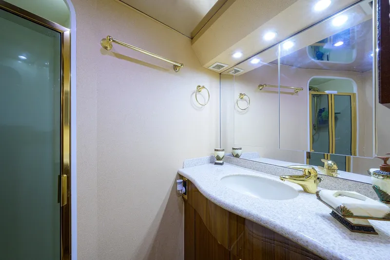  Yacht Photos Pics Luxurious bathroom in 2005 Viking 61 yacht with elegant fixtures and mirrored cabinetry.