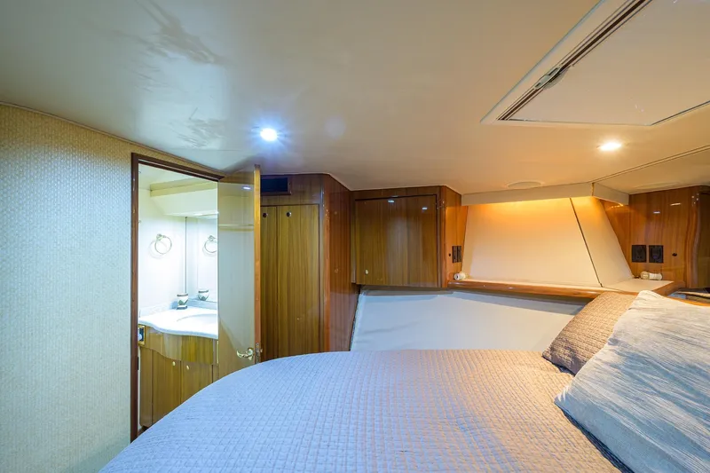  Yacht Photos Pics Luxurious cabin interior of 2005 Viking 61 yacht with cozy bed and ensuite bathroom.