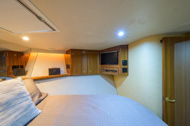  Yacht Photos Pics Luxurious cabin interior of a 2005 Viking 61 yacht with wood paneling and modern amenities.