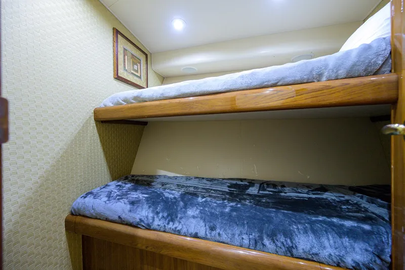  Yacht Photos Pics Bunk beds in 2005 Viking 61 yacht cabin with cozy bedding and wall art.