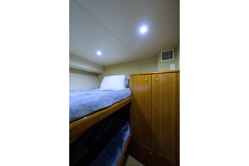  Yacht Photos Pics Cozy cabin interior of 2005 Viking 61 yacht with bunk beds and wooden cabinetry.