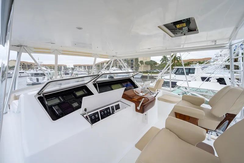  Yacht Photos Pics Luxurious 2005 Viking 61 yacht helm with modern controls and comfortable seating.