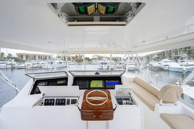  Yacht Photos Pics 2005 Viking 61 yacht helm with navigation controls, overlooking marina with docked boats.