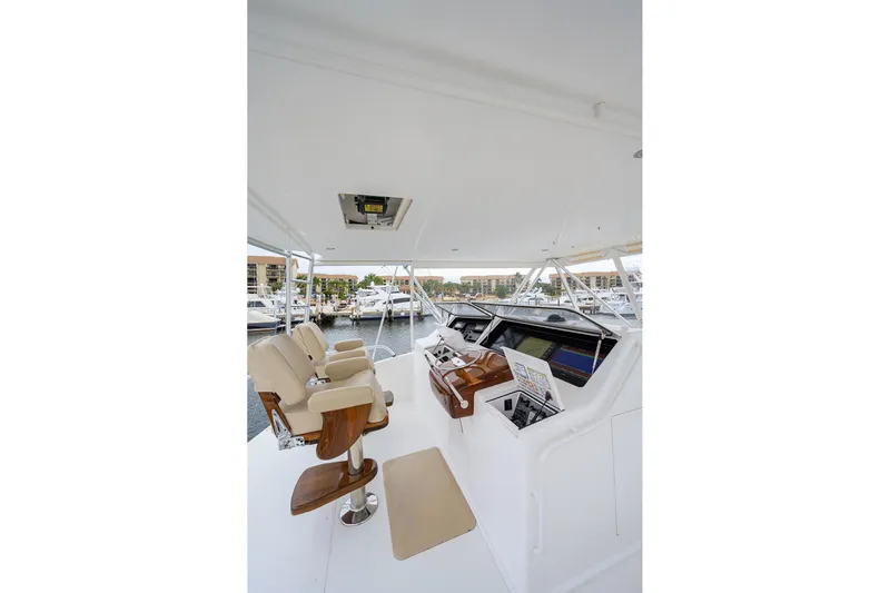  Yacht Photos Pics Helm of 2005 Viking 61 yacht with beige seats and navigation equipment.