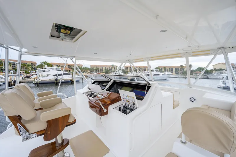  Yacht Photos Pics Luxurious 2005 Viking 61 yacht helm with leather seats and marina view.