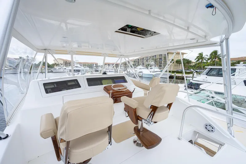  Yacht Photos Pics Luxurious helm of 2005 Viking 61 yacht with beige seating and modern controls.