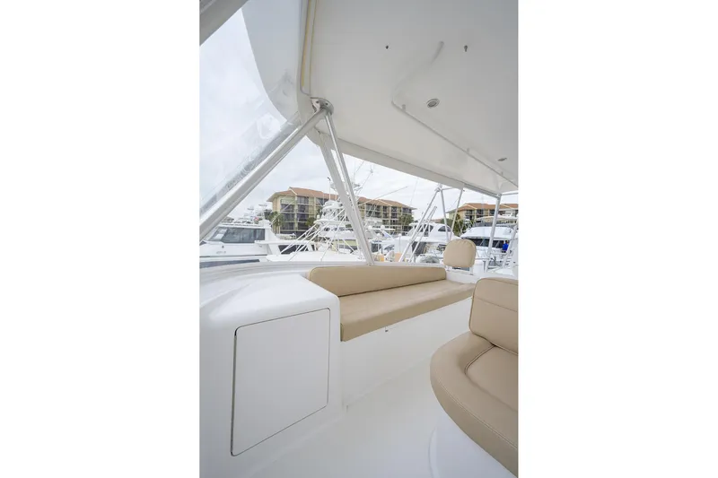  Yacht Photos Pics 2005 Viking 61 yacht interior with beige seating and marina view.