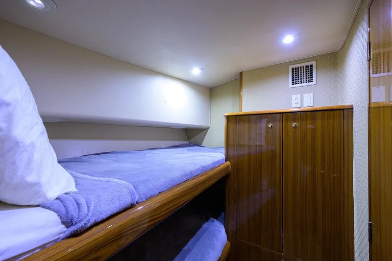  Yacht Photos Pics Cozy cabin interior of 2005 Viking 61 yacht with bunk beds and wooden cabinetry.