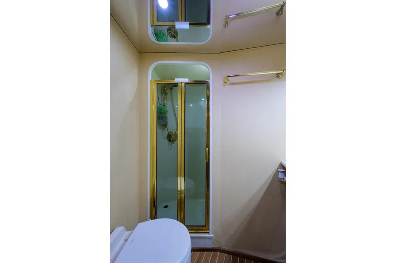  Yacht Photos Pics Luxurious bathroom in 2005 Viking 61 yacht with glass shower and elegant fixtures.