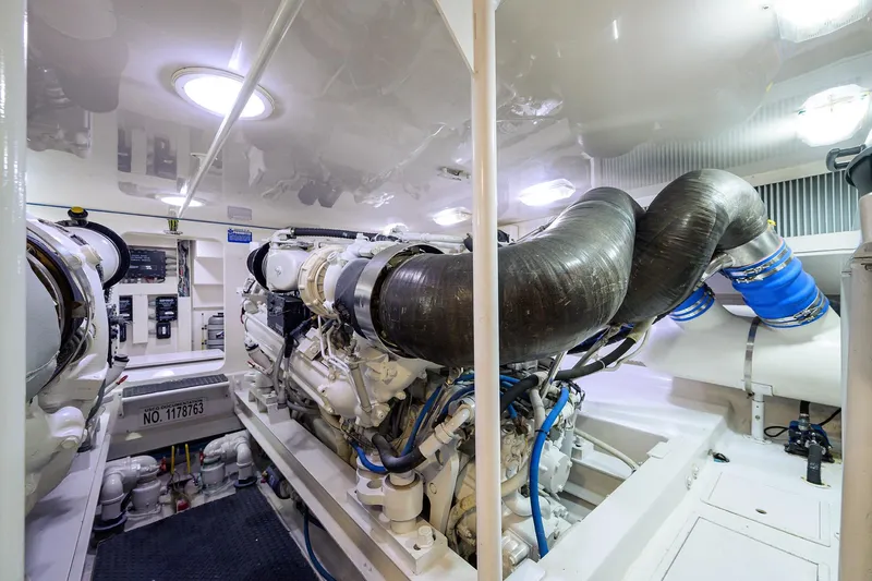  Yacht Photos Pics Engine room of a 2005 Viking 61 yacht, showcasing complex machinery and piping.