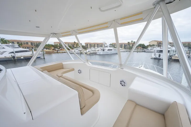  Yacht Photos Pics Luxurious 2005 Viking 61 yacht interior with beige seating, overlooking marina.