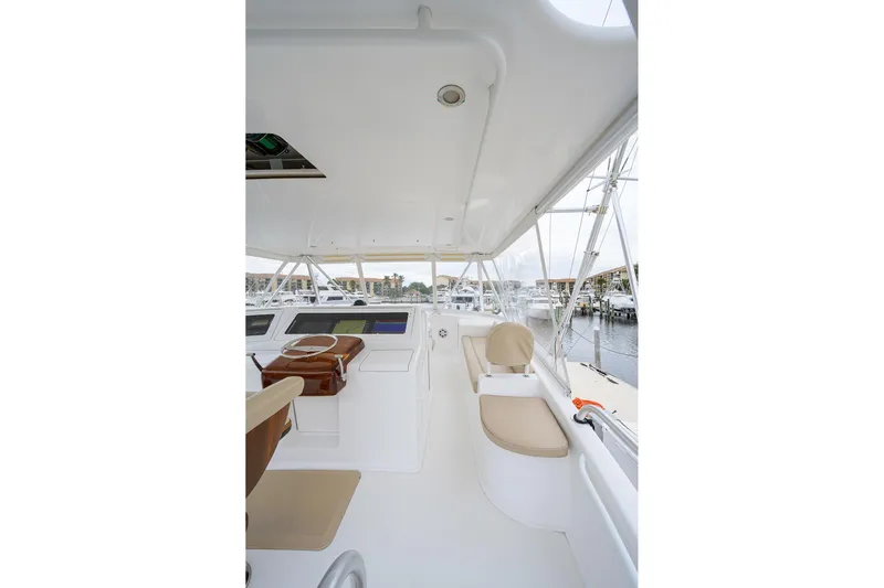  Yacht Photos Pics 2005 Viking 61 yacht helm with beige seating and marina view.