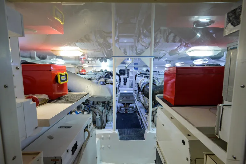  Yacht Photos Pics Engine room of a 2005 Viking 61 yacht, featuring organized equipment and red toolboxes.