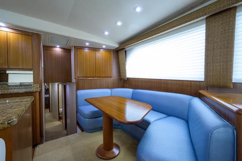  Yacht Photos Pics Luxurious interior of 2005 Viking 61 yacht with blue seating and wooden accents.