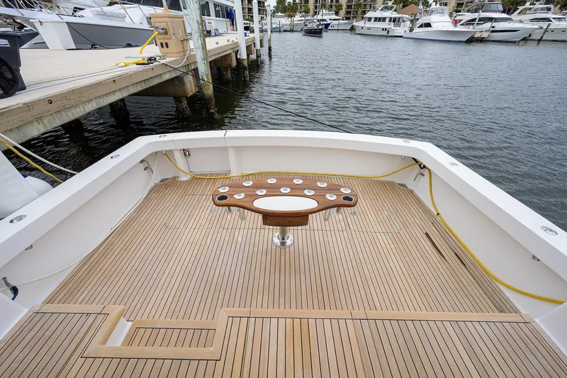  Yacht Photos Pics 2005 Viking 61 yacht deck with wooden flooring and fishing station at marina.