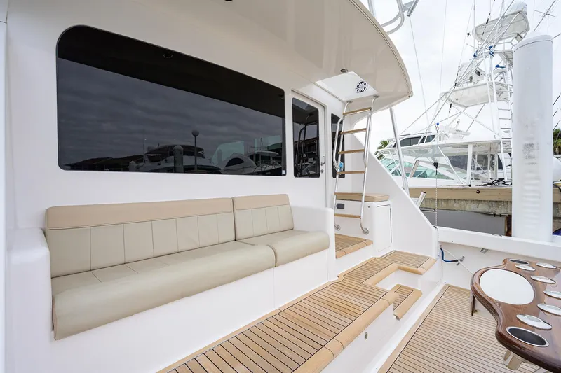  Yacht Photos Pics 2005 Viking 61 yacht deck with beige seating and wooden flooring.