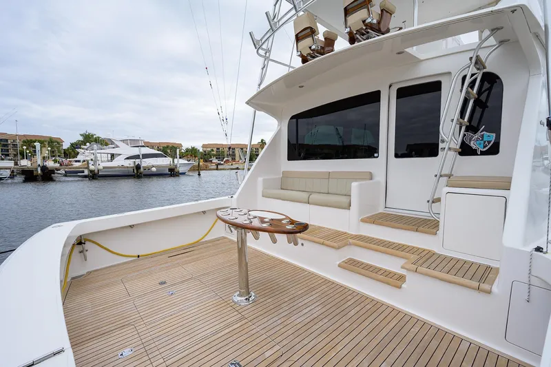  Yacht Photos Pics 2005 Viking 61 yacht deck with seating, table, and marina view.