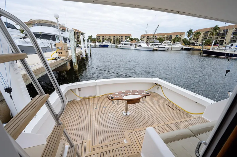  Yacht Photos Pics 2005 Viking 61 yacht deck overlooking marina with boats and waterfront buildings.