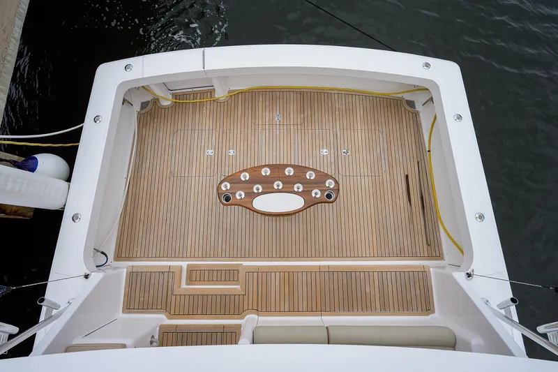  Yacht Photos Pics 2005 Viking 61 yacht deck with teak flooring and fishing rod holders.
