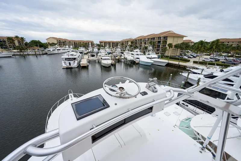  Yacht Photos Pics Aerial view from 2005 Viking 61 yacht helm overlooking marina with multiple boats docked.