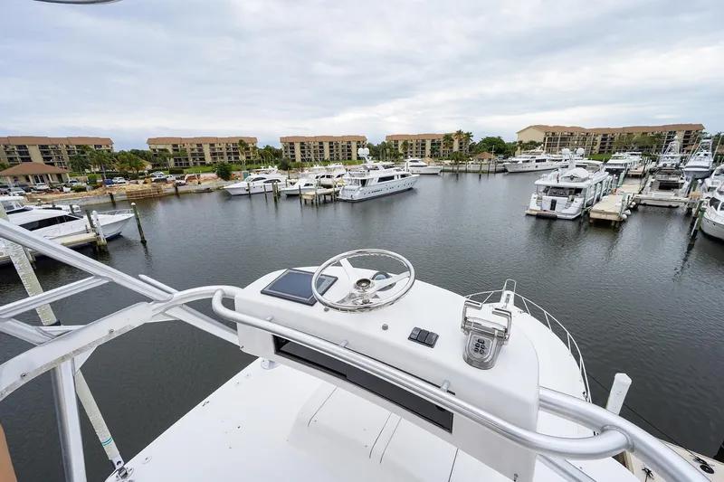  Yacht Photos Pics View from 2005 Viking 61 yacht helm overlooking marina with docked boats and waterfront buildings.