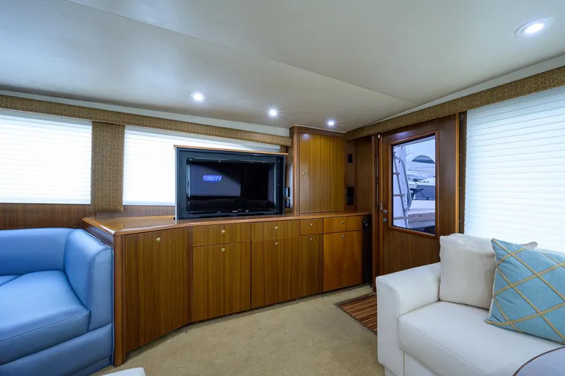  Yacht Photos Pics Luxurious interior of 2005 Viking 61 yacht with wood cabinetry and comfortable seating.