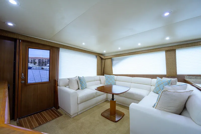  Yacht Photos Pics Luxurious interior of 2005 Viking 61 yacht with white seating and wooden accents.
