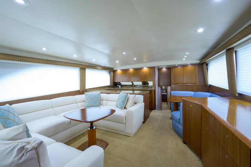  Yacht Photos Pics Luxurious interior of 2005 Viking 61 yacht with elegant seating and wooden cabinetry.