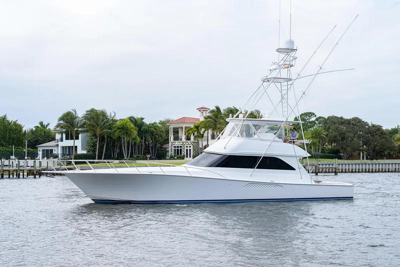  Yacht Photos Pics 2005 Viking 61 yacht cruising near waterfront homes with palm trees.