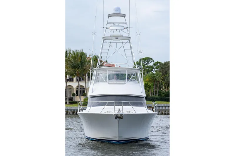  Yacht Photos Pics 2005 Viking 61 yacht on water, front view with lush greenery background.