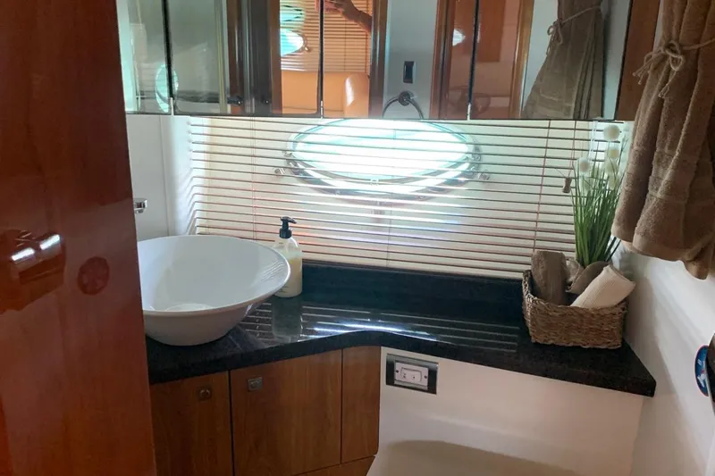 Bes Yacht Photos Pics Luxurious bathroom in 2007 Sunseeker Predator 62 yacht with modern sink and decor.