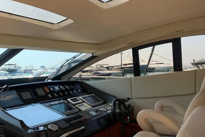 Bes Yacht Photos Pics Interior view of 2007 Sunseeker Predator 62 yacht cockpit with control panel and seating.