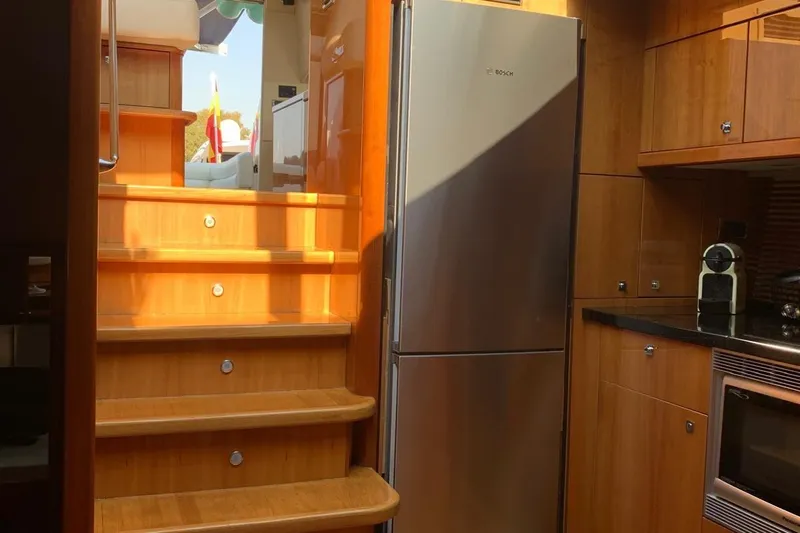 Bes Yacht Photos Pics Interior of 2007 Sunseeker Predator 62 yacht with wooden stairs and modern kitchen.