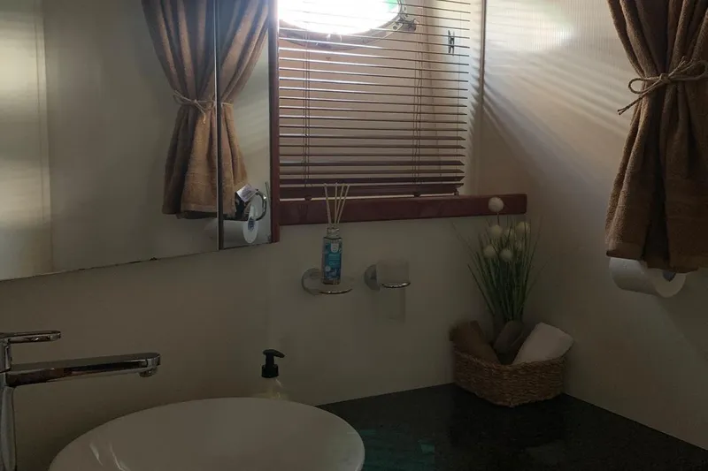 Bes Yacht Photos Pics Bathroom interior of 2007 Sunseeker Predator 62 yacht with sink, mirror, and window blinds.