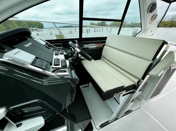 The Mabel Coe Yacht Photos Pics 2018 Monterey 360 Sport Coupe helm with leather seating and modern controls.