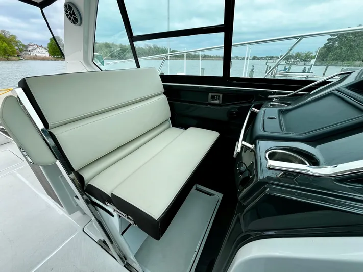 The Mabel Coe Yacht Photos Pics 2018 Monterey 360 Sport Coupe interior helm with white seating and water view.