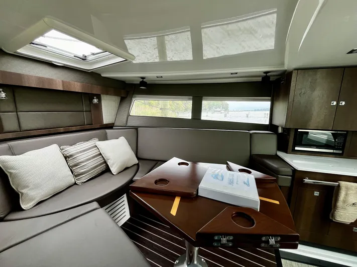 The Mabel Coe Yacht Photos Pics Interior of 2018 Monterey 360 Sport Coupe with modern seating and kitchenette.