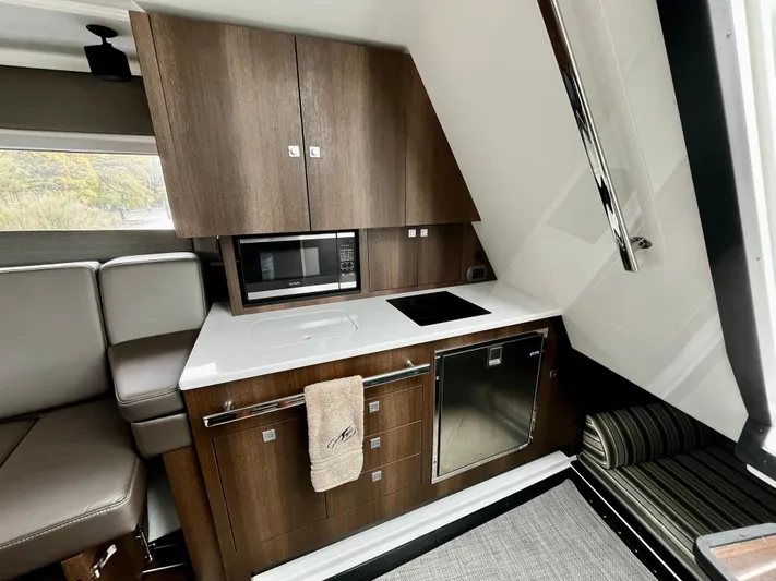 The Mabel Coe Yacht Photos Pics Modern kitchen area in 2018 Monterey 360 Sport Coupe yacht with microwave and sleek cabinetry.