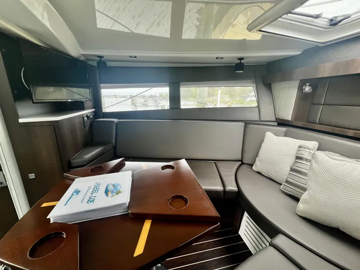 The Mabel Coe Yacht Photos Pics Interior of 2018 Monterey 360 Sport Coupe with modern seating and table.