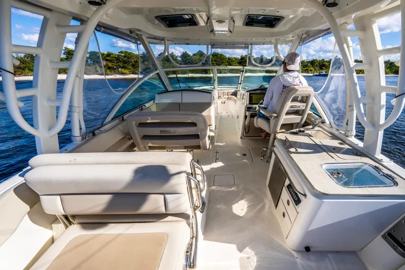 It's Been Reel Yacht Photos Pics 2019 Boston Whaler 320 Vantage interior, featuring seating and helm, cruising on a sunny day.
