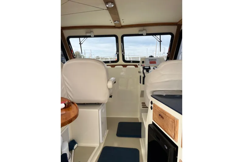  Yacht Photos Pics Interior of 2020 Eastern 27 Islander boat with white seating and navigation equipment.