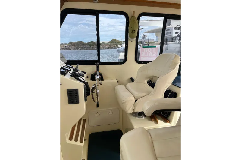  Yacht Photos Pics Interior of 2020 Eastern 27 Islander boat with steering wheel and captain's chair.