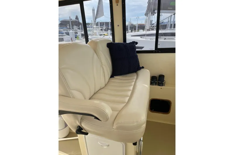  Yacht Photos Pics Luxurious interior seating of 2020 Eastern 27 Islander boat with plush cushion and window view.