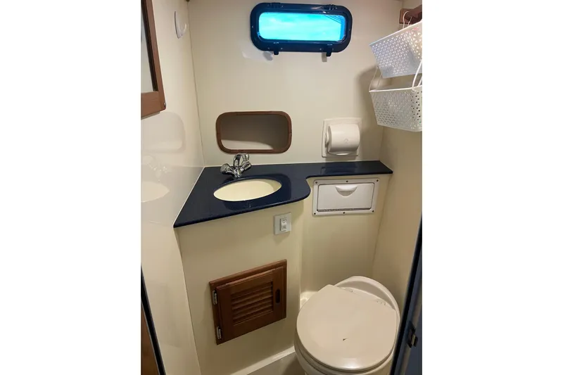  Yacht Photos Pics 2020 Eastern 27 Islander boat bathroom with sink, toilet, and storage.