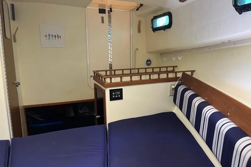  Yacht Photos Pics 2020 Eastern 27 Islander boat interior with blue cushions and striped seating.