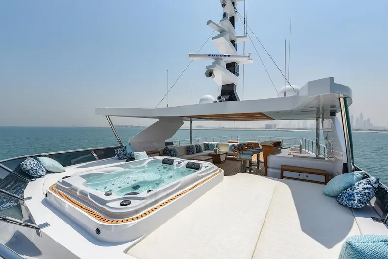  Yacht Photos Pics Luxurious 2026 Majesty 120 yacht with jacuzzi and seating area on deck.