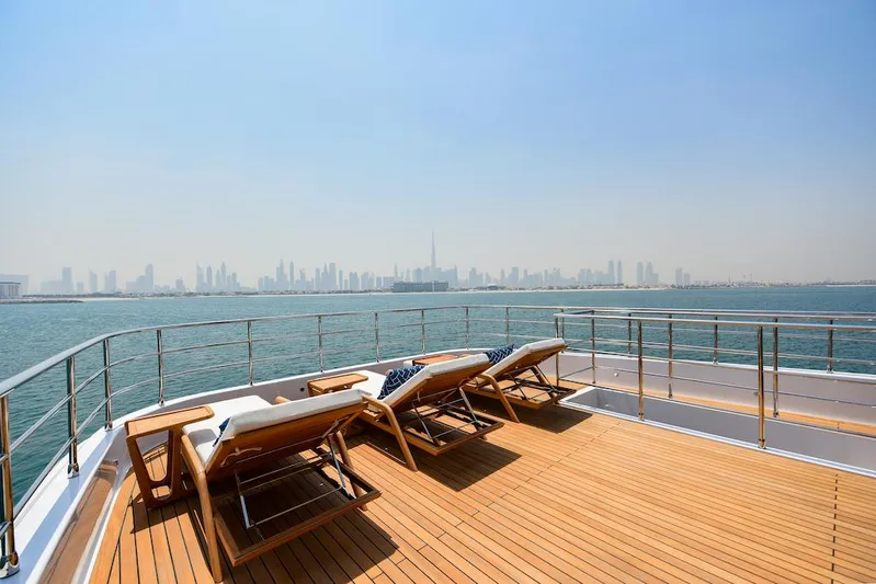  Yacht Photos Pics Luxury yacht deck with sun loungers, city skyline view; Majesty 120, 2026 model.