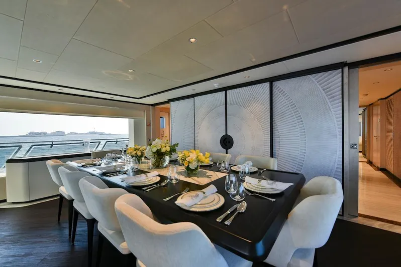  Yacht Photos Pics Luxurious dining area on 2026 Majesty 120 yacht with elegant table setting.