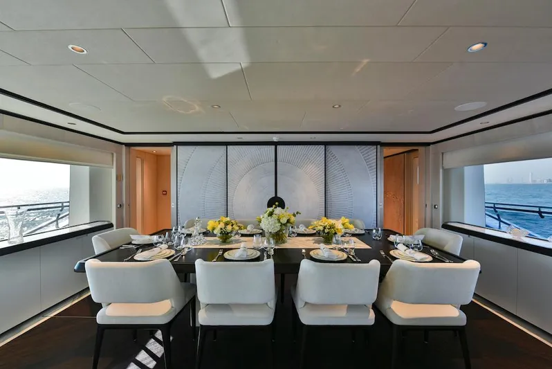  Yacht Photos Pics Luxurious dining area on 2026 Majesty 120 yacht, elegantly set table with ocean view.