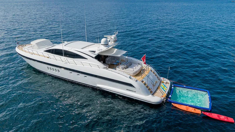 Deva I Yacht Photos Pics Luxurious 2008 Mangusta 92 yacht on open sea with floating platform and kayaks.
